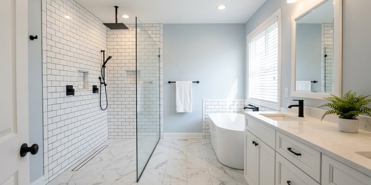 A fully remodeled bathroom with a new vanity, mirror and tiled tub surround